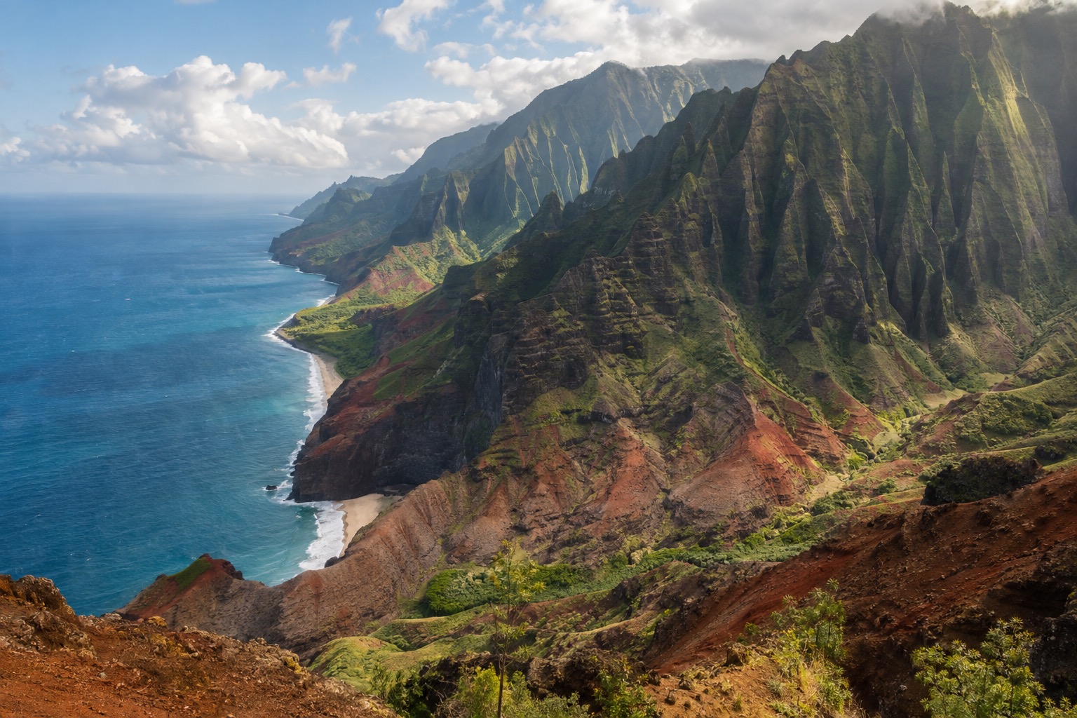 A red-rock canyon with layered cliffs and green ridgelines under a partly cloudy sky