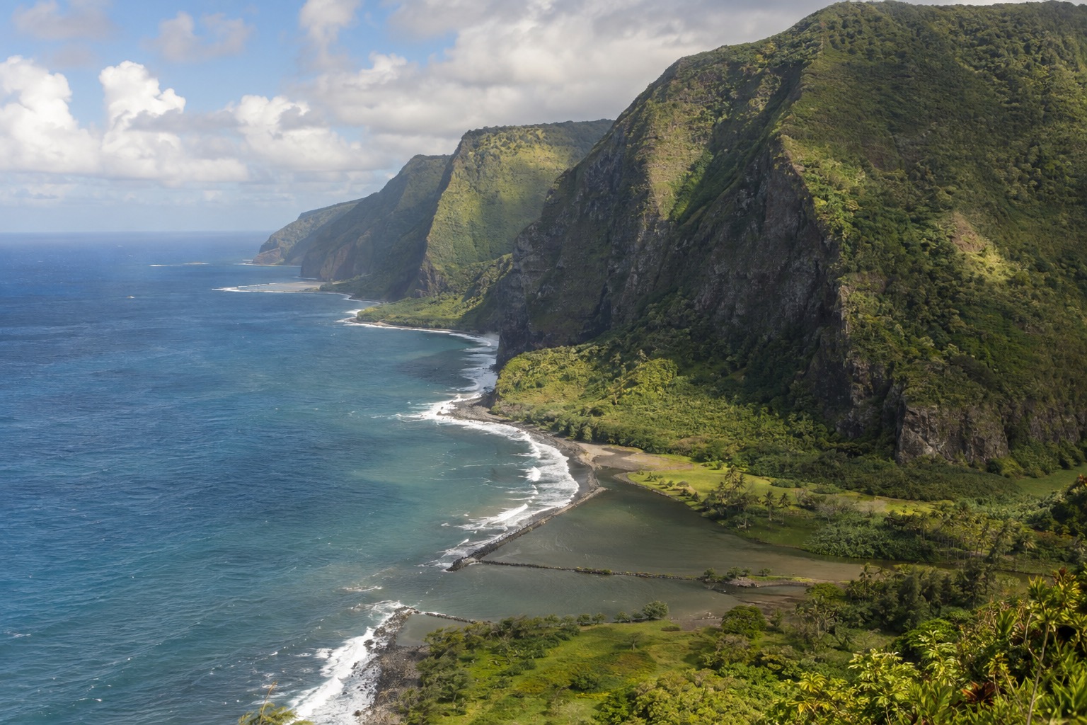 Volcanic sea cliffs along Molokai's undeveloped north shore coastline