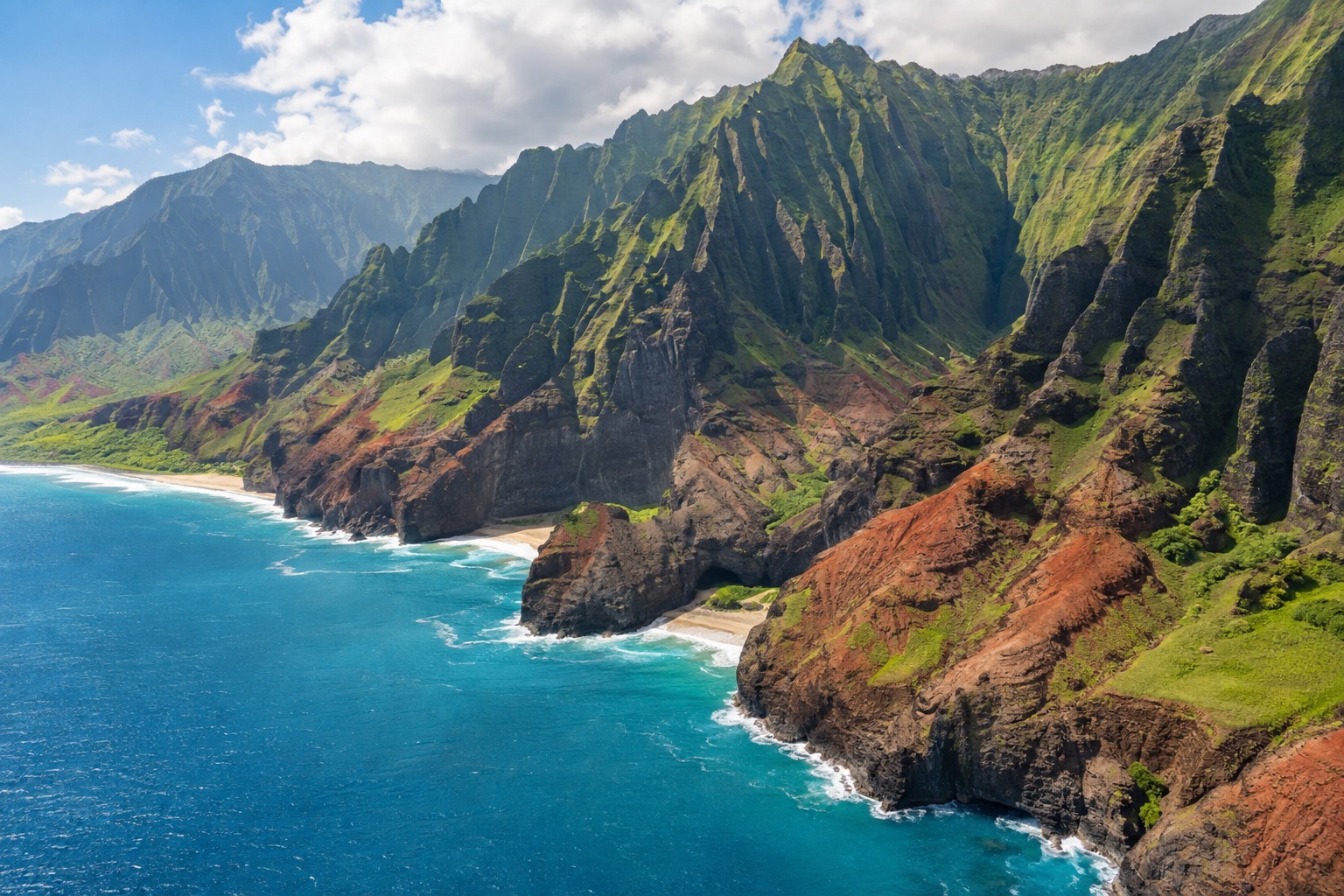 Fluted green cliffs and hanging valleys along a roadless coastline in Kauai