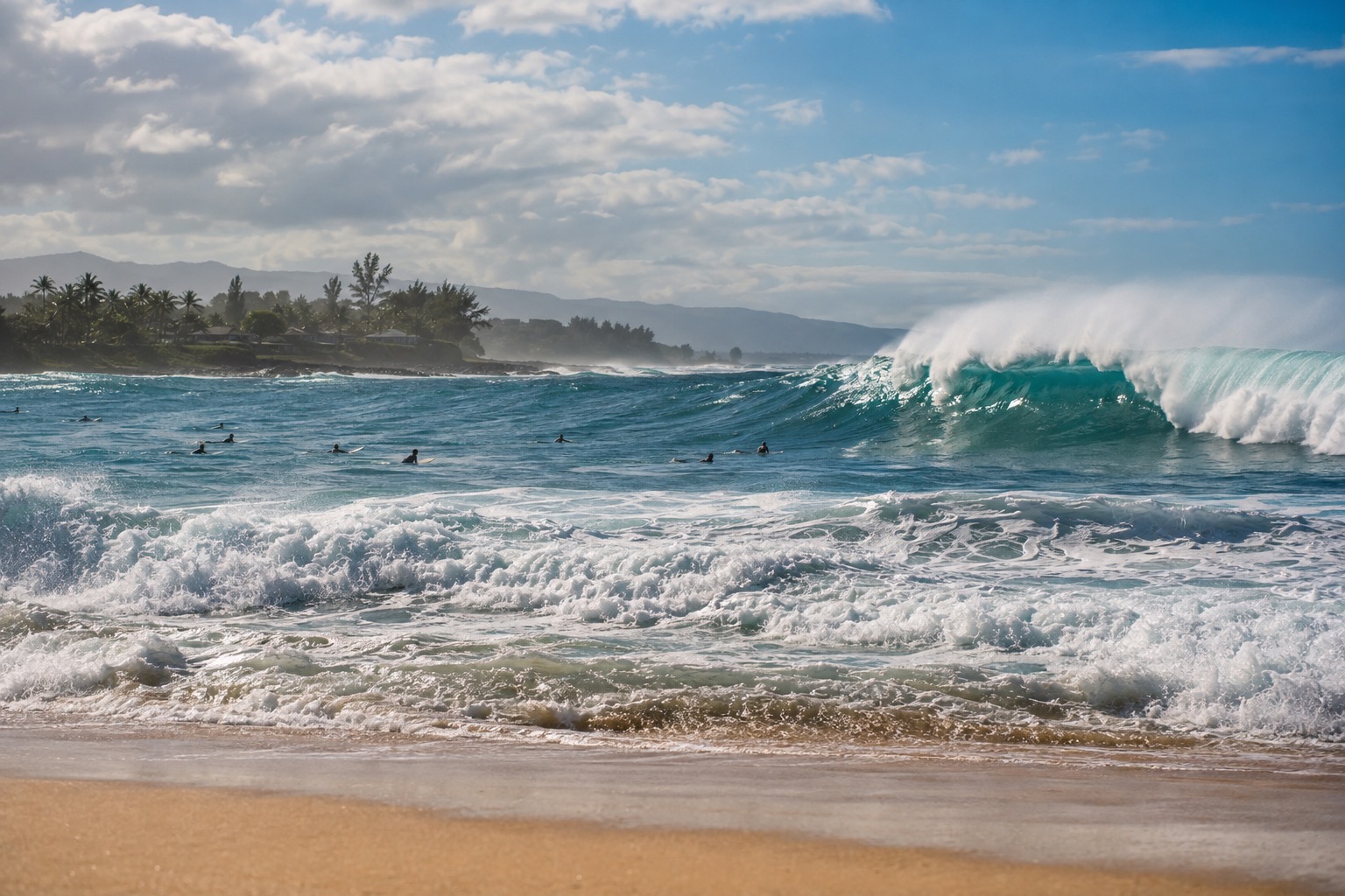 Large waves breaking close to shore at a North Shore beach with surfers paddling out