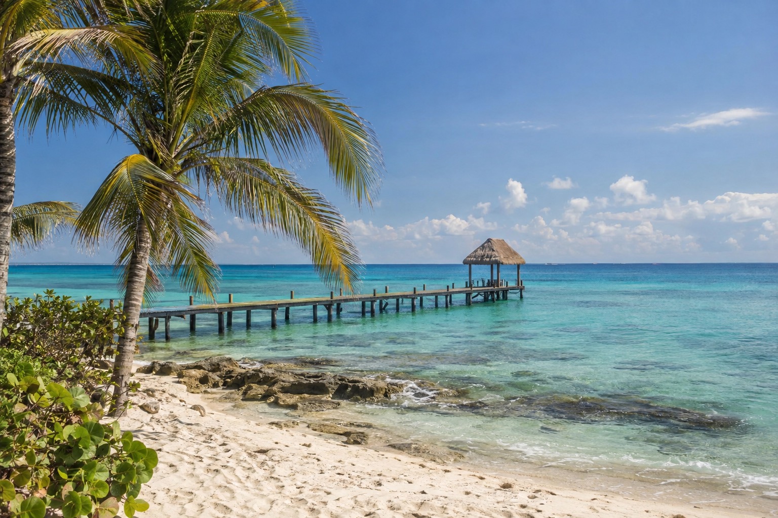 A long pier stretching into turquoise water on the west coast of Cozumel, Mexico