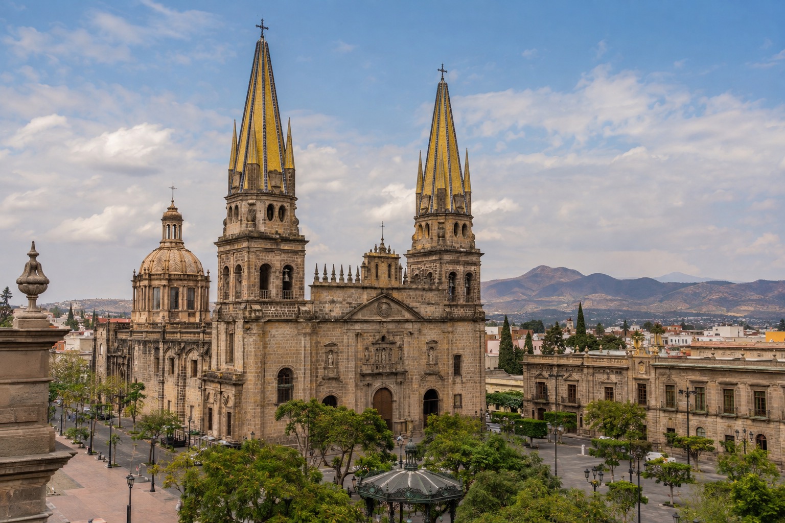 Cathedral with twin yellow-tiled spires beside a plaza in Guadalajara's historic center