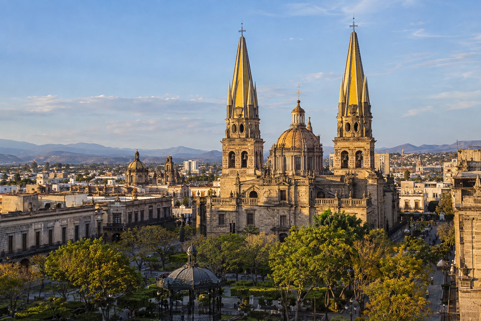 Twin yellow-tiled spires of Guadalajara's cathedral rising above the Plaza de Armas