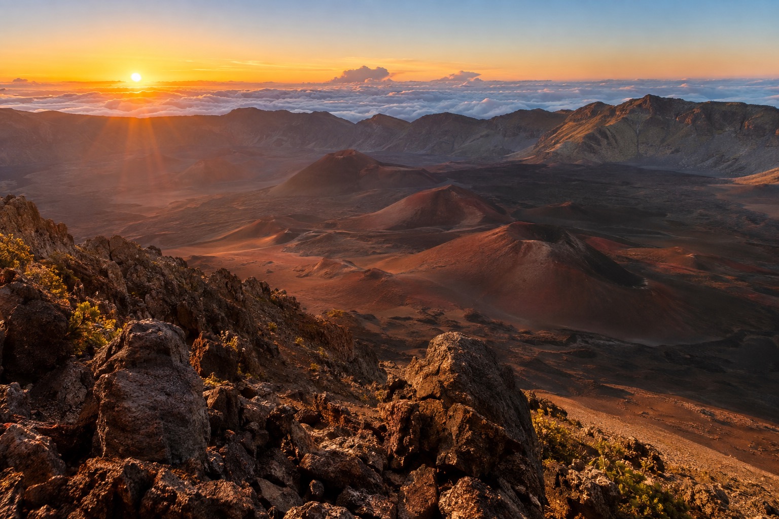Sunrise light over red and black cinder cones inside Haleakala's summit crater