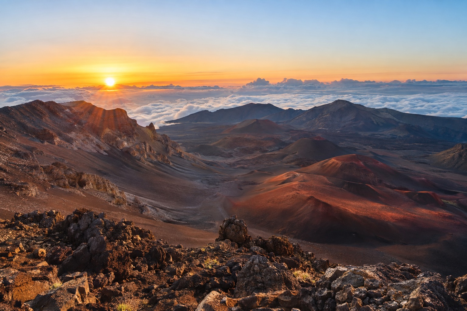The red and black cinder cones inside Haleakala's summit crater at sunrise