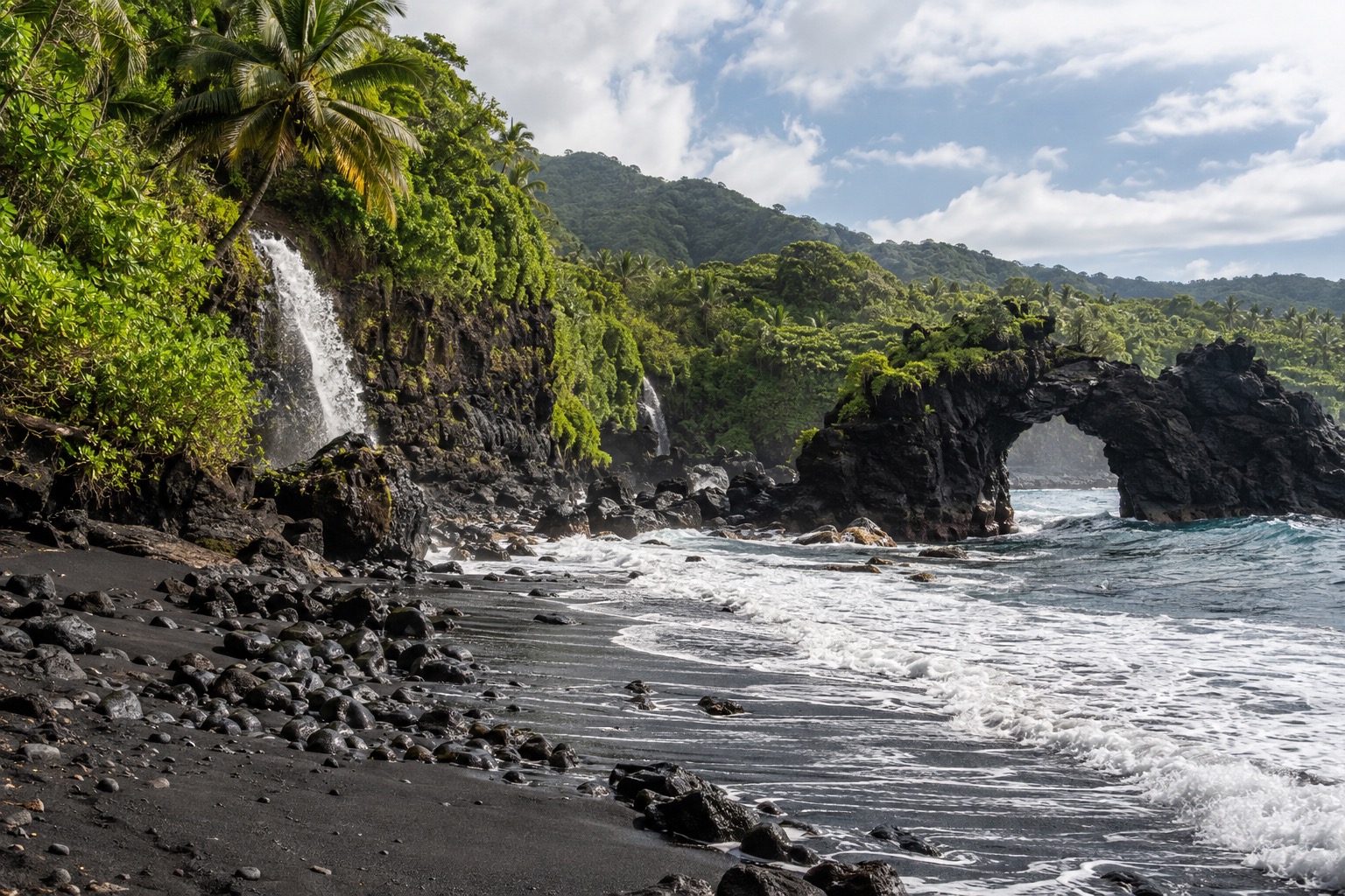 Black sand beach and a natural stone arch at a Maui coastal state park