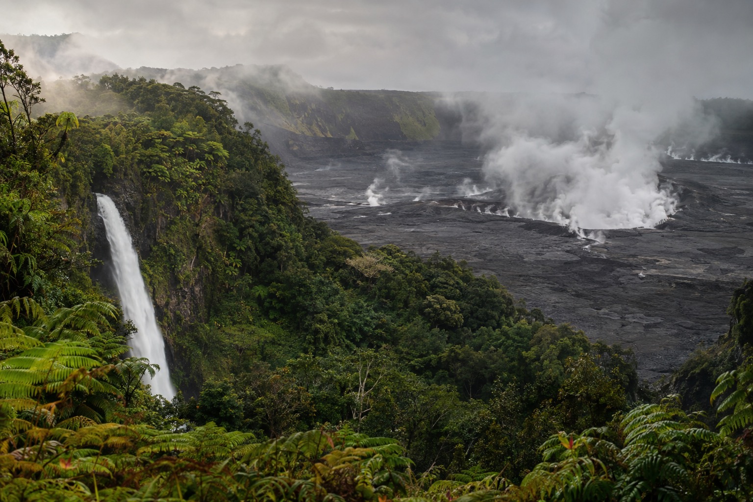Steam rising from cracks in a volcanic caldera floor at Hawaii Volcanoes National Park