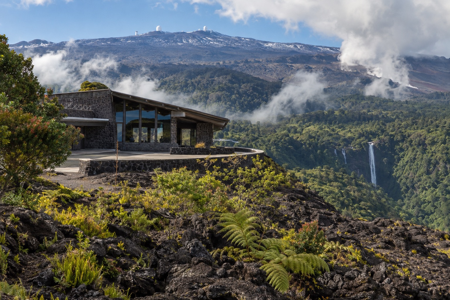 The Onizuka Visitor Information Station on Maunakea's slope with the summit ridge in the distance