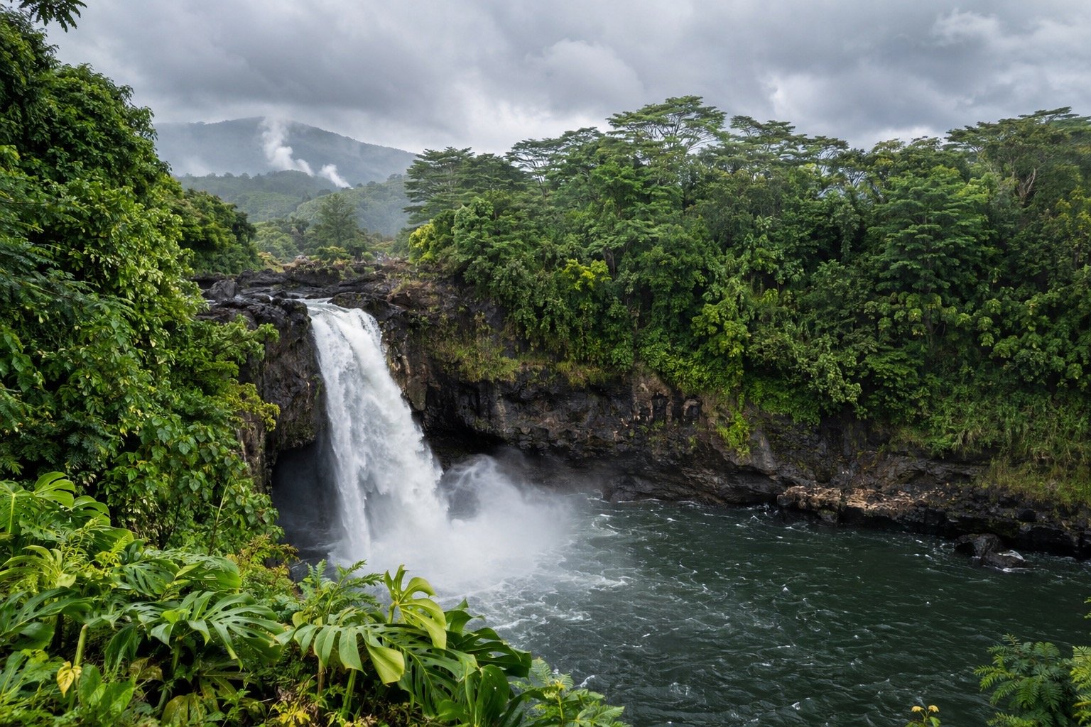 Rainbow Falls flowing over a lava-rock ledge in Wailuku River State Park, Hilo