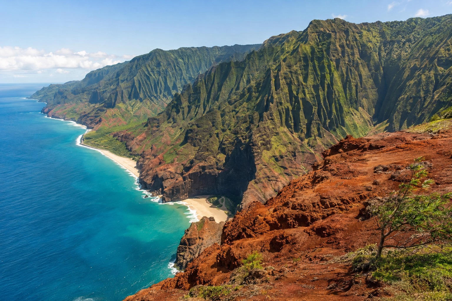 A dry, rust-colored canyon with layered cliffs and green ridges under a clear sky on Kauai's west side