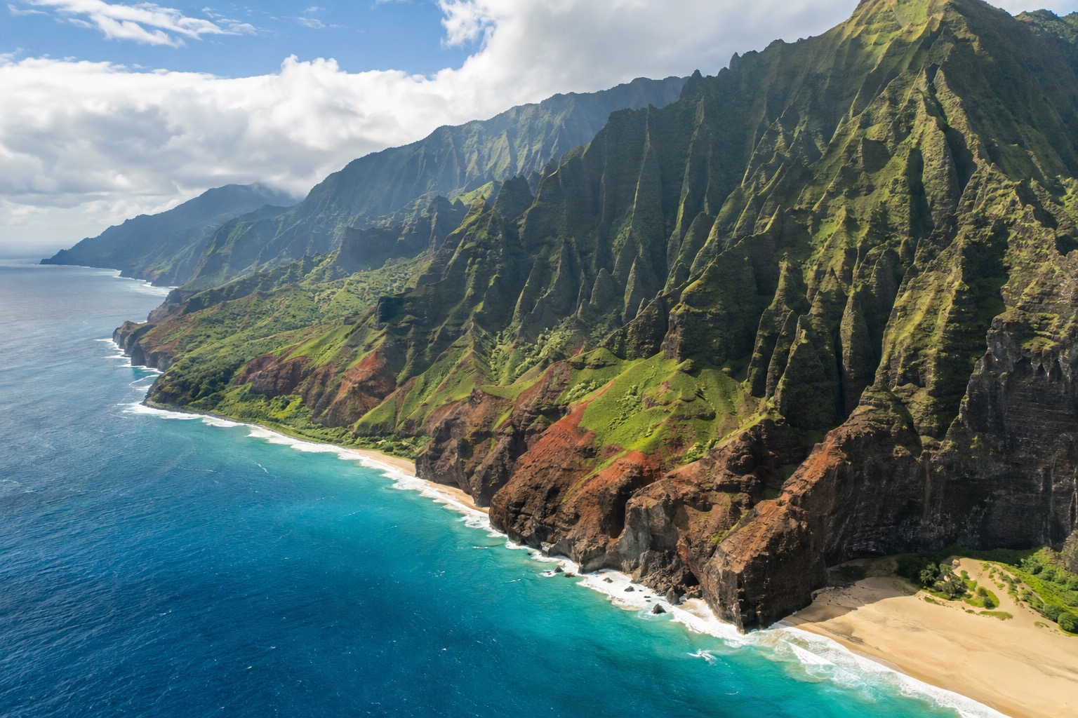 Steep, ridged green cliffs rising straight from the Pacific along a rugged coastline