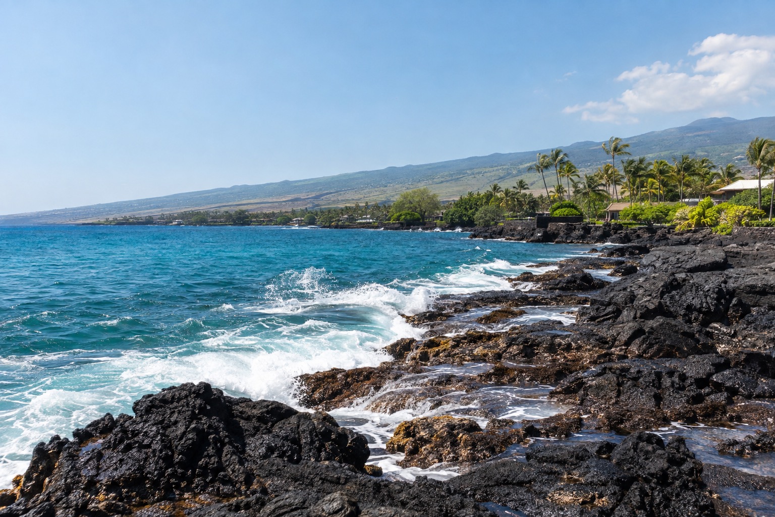 Waves breaking on black lava rock along Ali'i Drive in Kailua-Kona