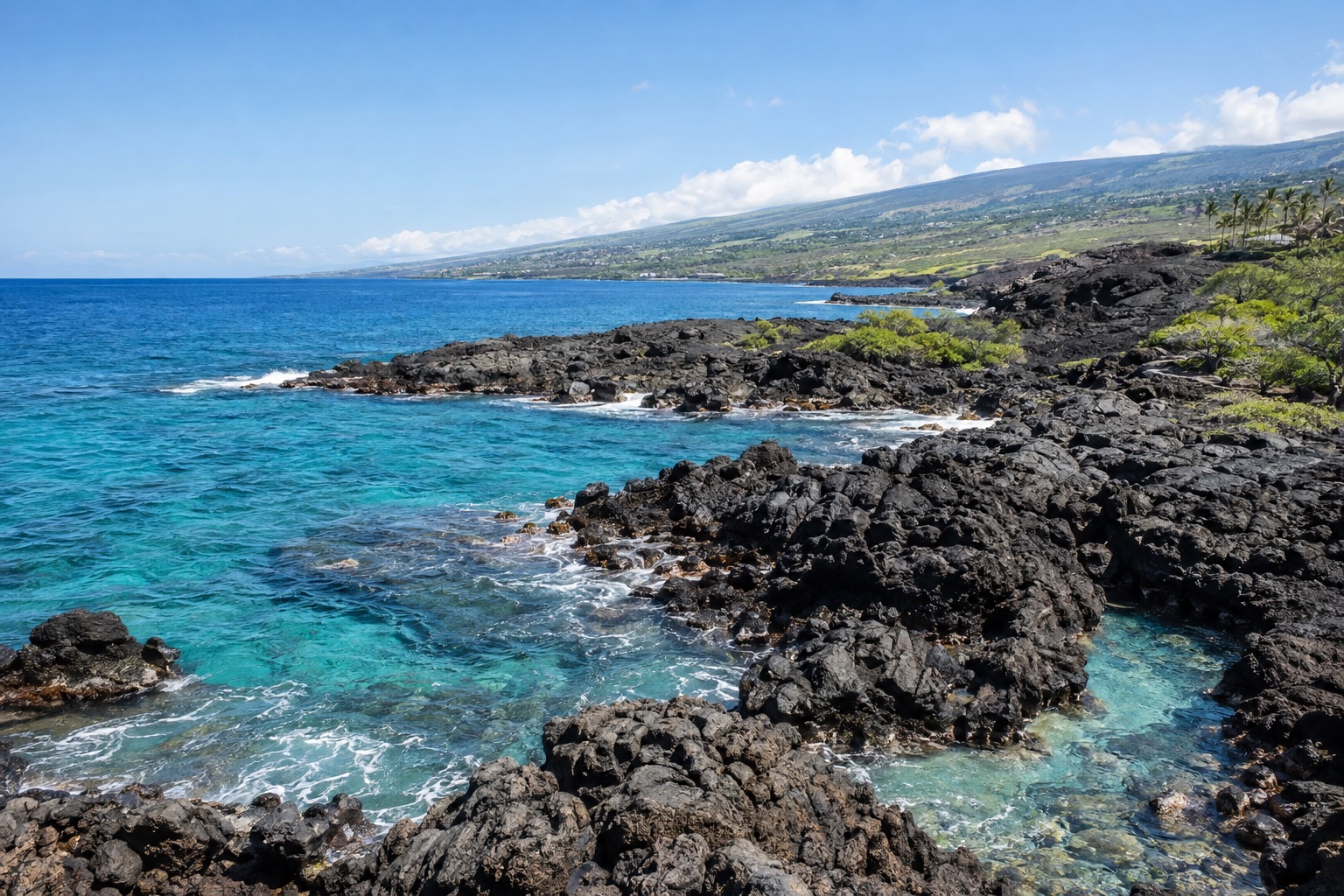 Lava-rock coastline and turquoise water near Kailua-Kona under a clear October sky