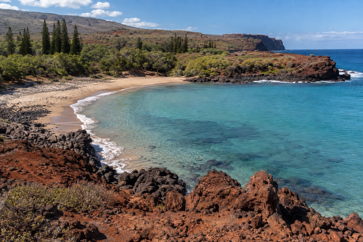 A quiet crescent beach cove on Lanai's south shore under midday sun