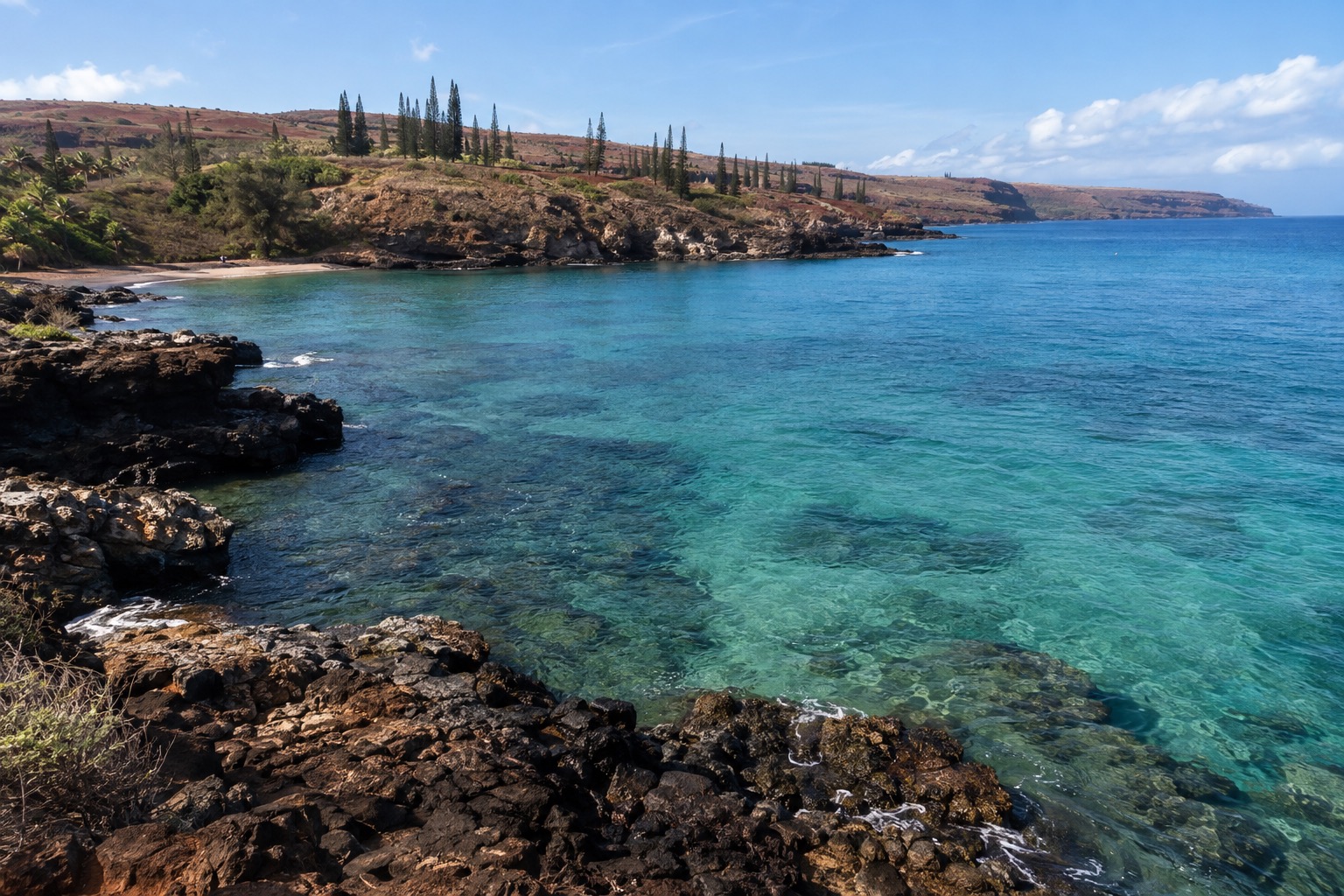 Turquoise water and volcanic rock at a marine reserve bay on Lanai
