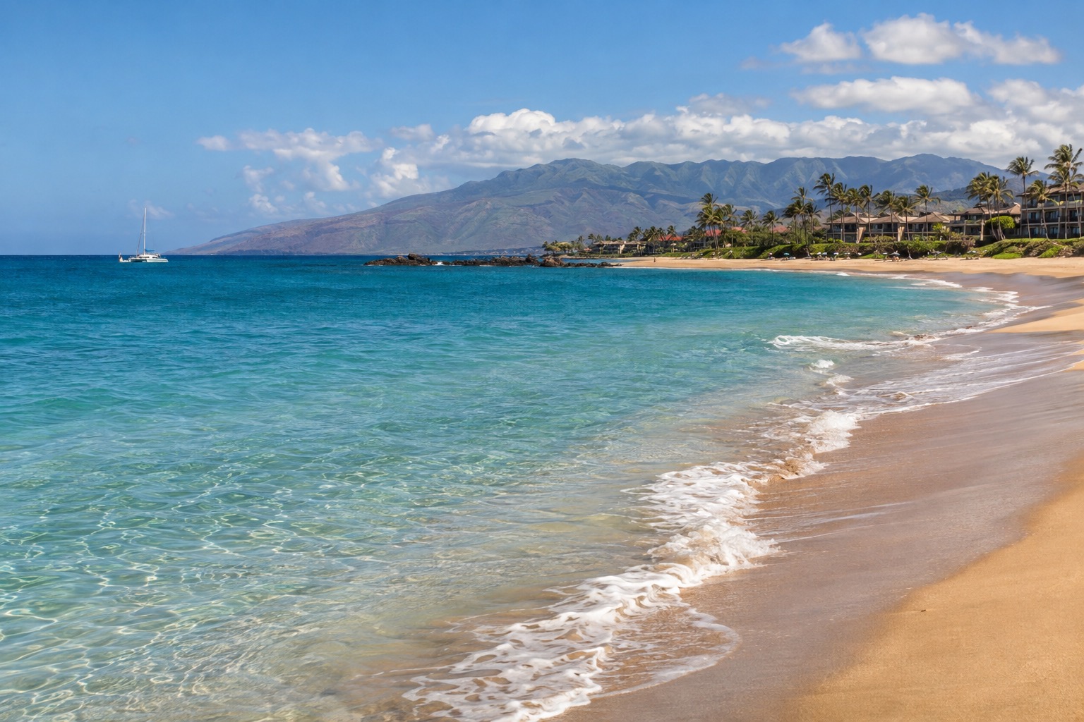 Turquoise water and white sand along West Maui's Kaanapali Beach in midday sun