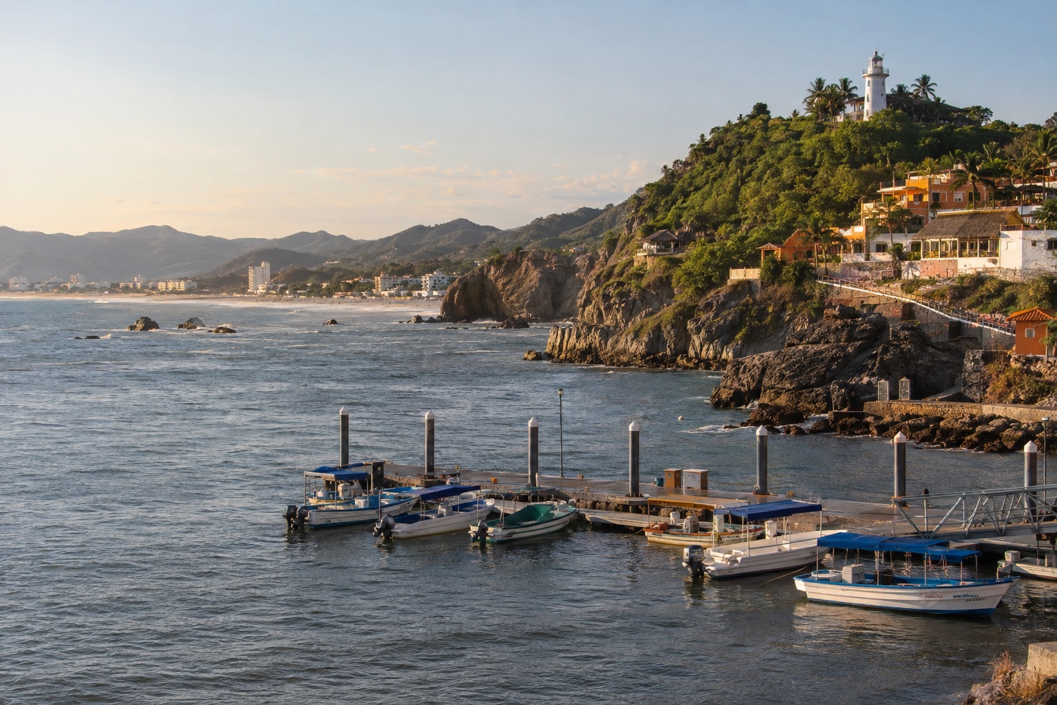 Small passenger boats moored at a pier below a lighthouse hill in Mazatlan