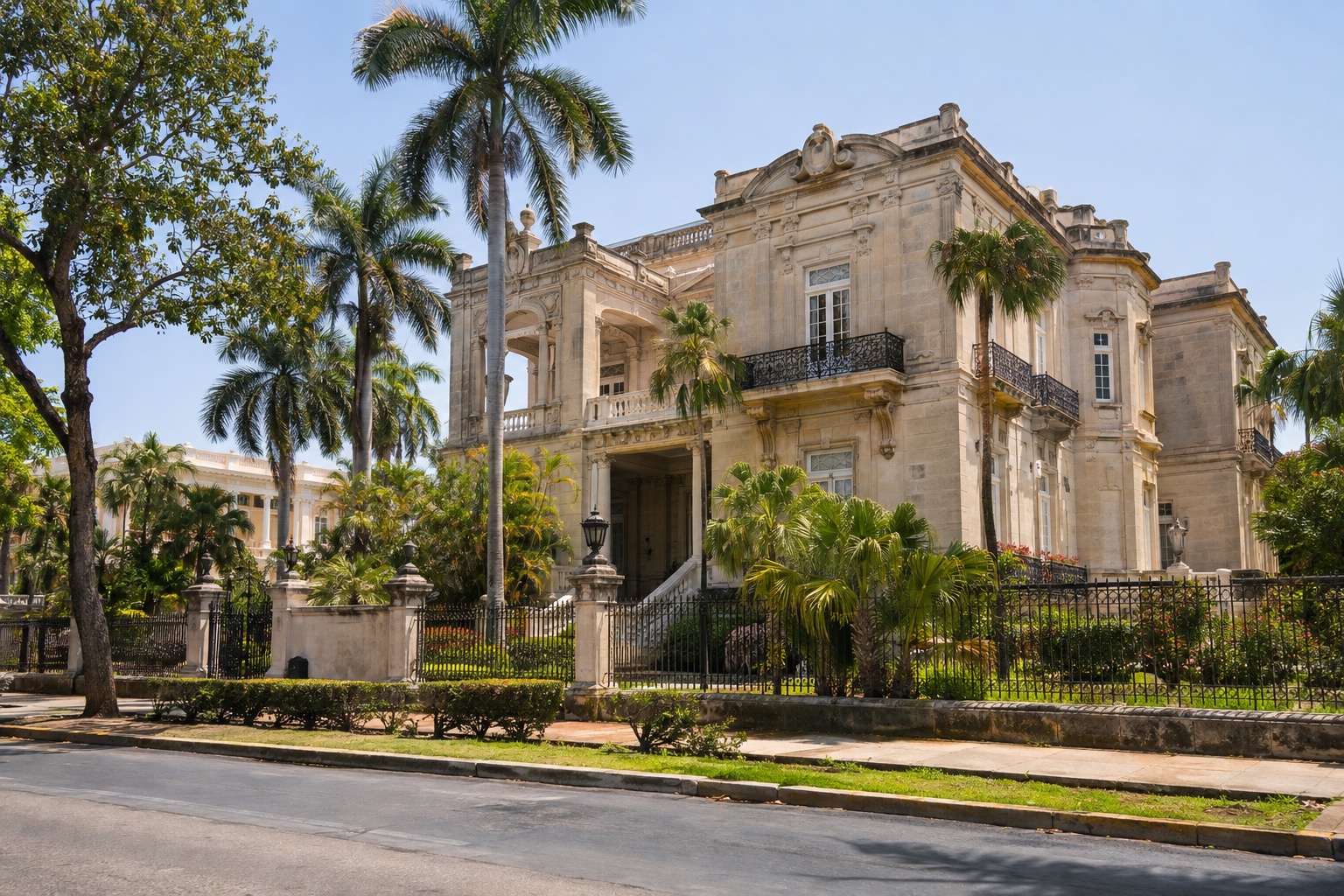 A colonial-era mansion with a stone facade along Paseo de Montejo in Merida under a clear sky