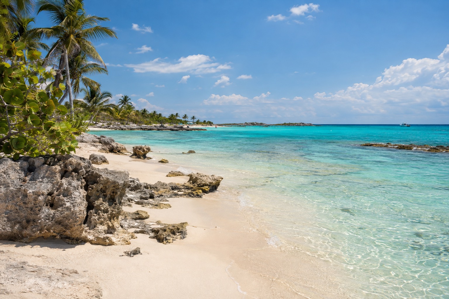 Bands of turquoise and deeper blue water across a lagoon with a pale limestone bottom