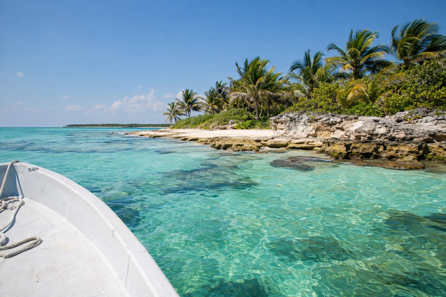 A ferry approaching a pier on the calm west coast of Cozumel in morning light