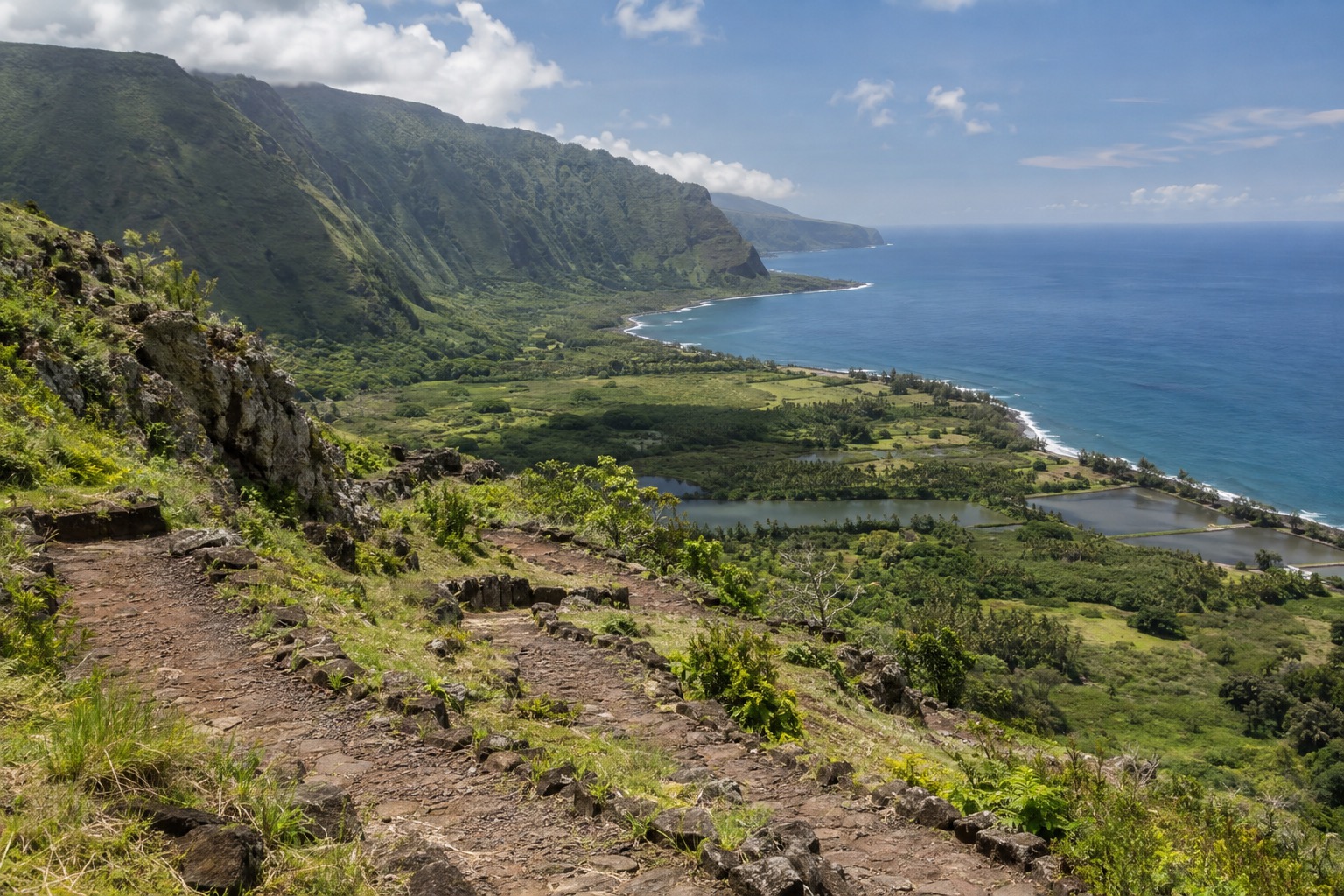 A switchback trail descending toward the Kalaupapa peninsula on Molokai