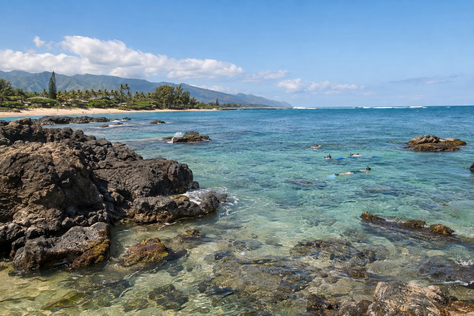 Snorkelers in a shallow rocky cove with calm turquoise water