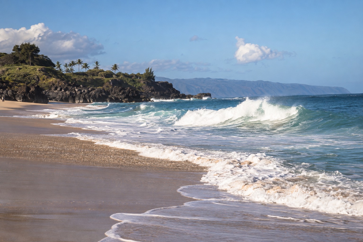 Waves breaking gently at Waimea Bay under a clear October sky