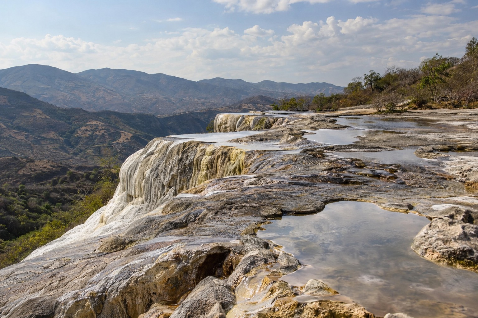 Petrified mineral waterfalls and rock pools on a hillside at Hierve el Agua near Oaxaca