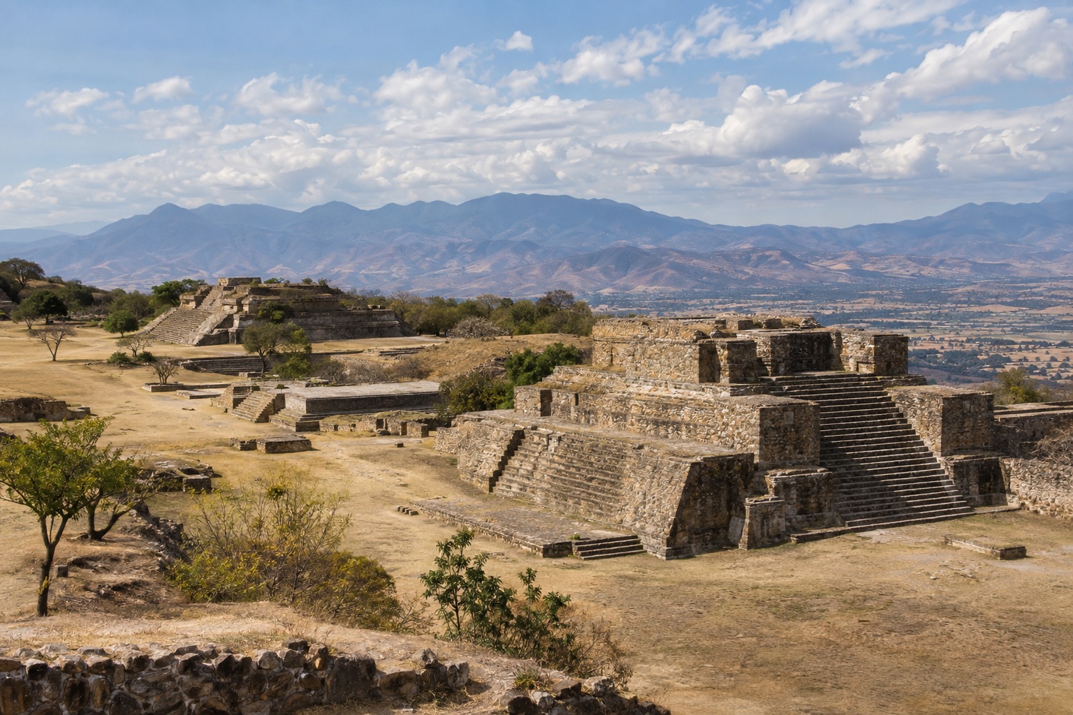 Stone platforms and stairways of the Monte Alban ruins on a hilltop above the Oaxaca valley