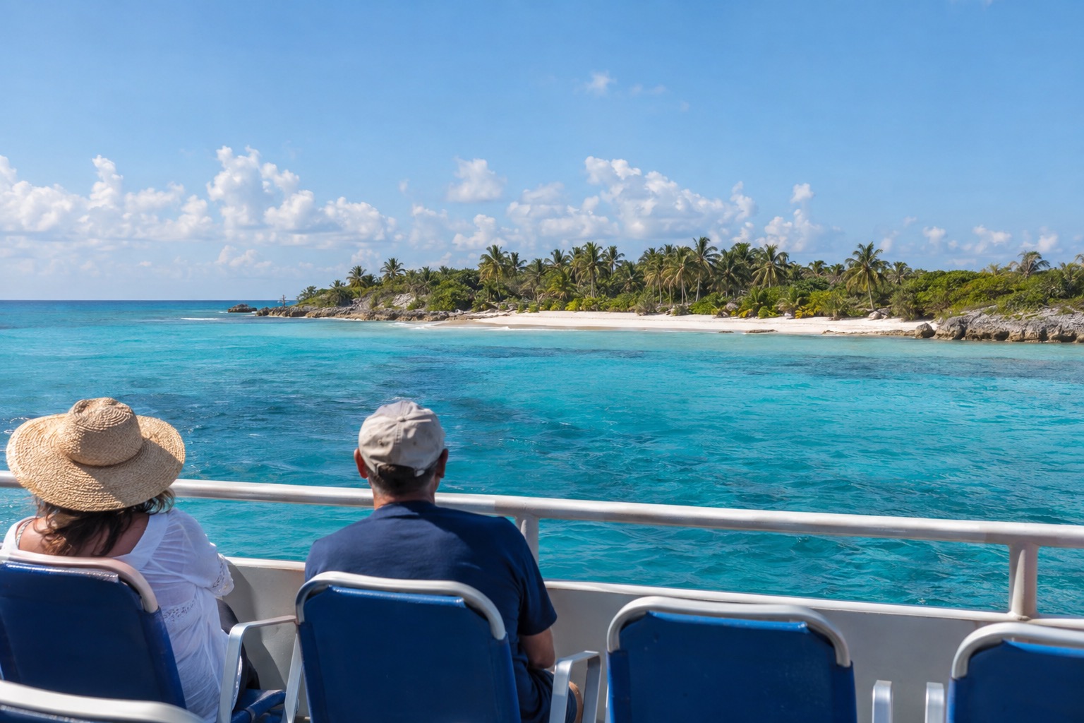 A passenger ferry crossing turquoise water toward Cozumel