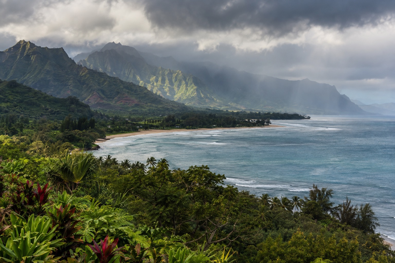 Rain clouds moving over Hanalei Bay seen from a bluff in Princeville
