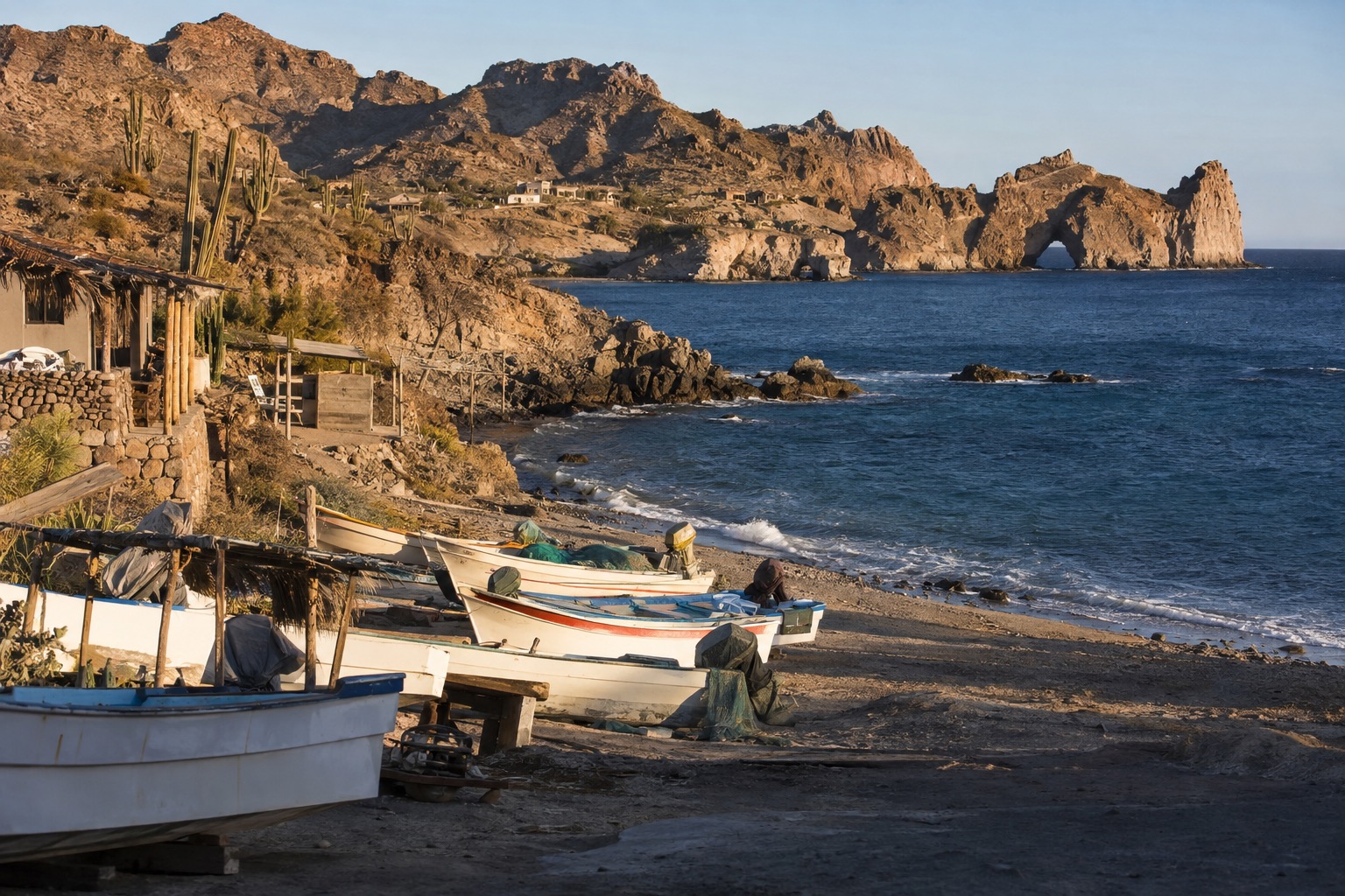 Small fishing boats pulled up on the sand beside a coastal village on the Pacific