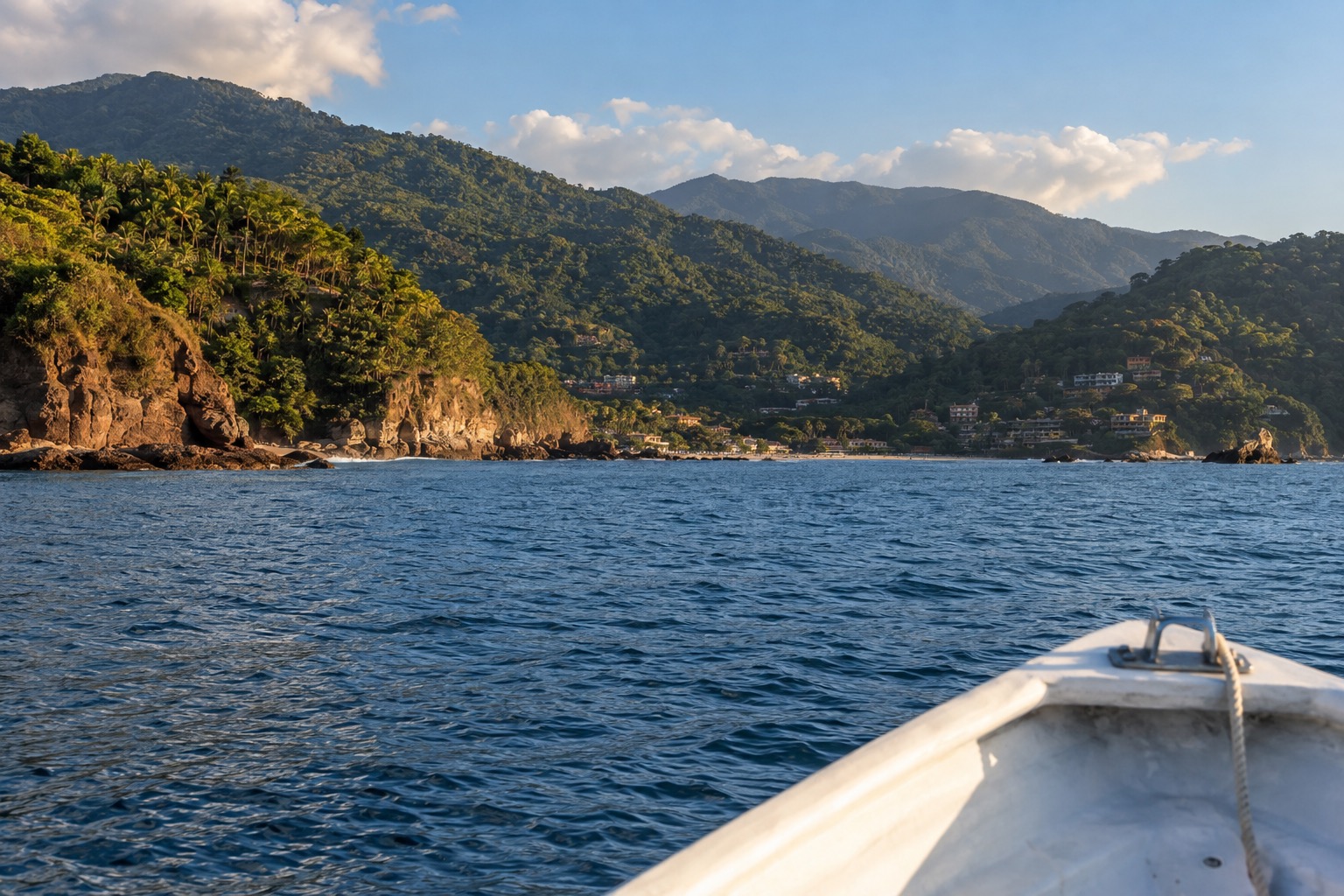 A boat crossing blue water toward rocky islands off the Pacific coast of Mexico