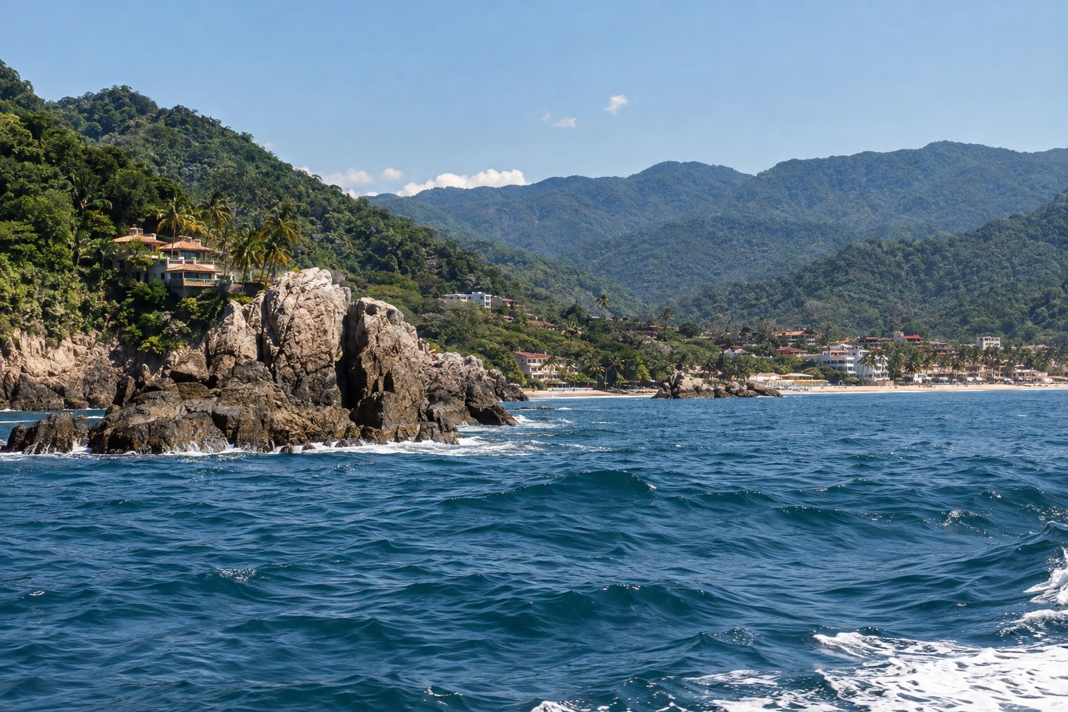 Open Pacific water off a rocky Nayarit coastline under a clear sky