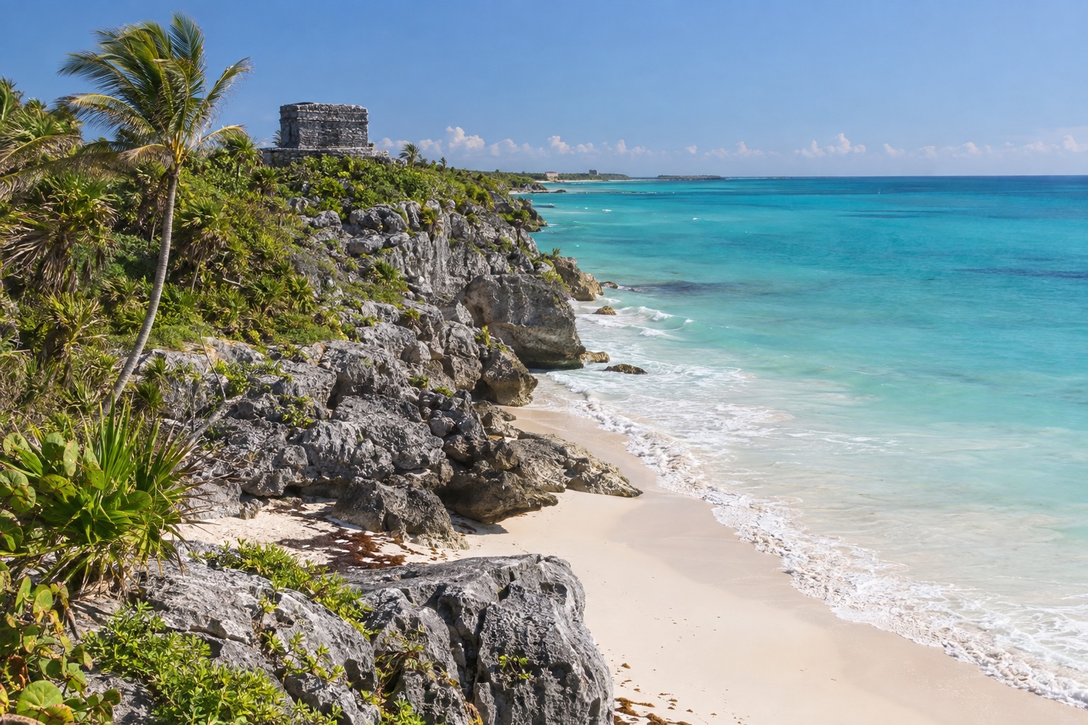 Ruins of a Maya coastal watchtower on a limestone cliff above turquoise Caribbean water