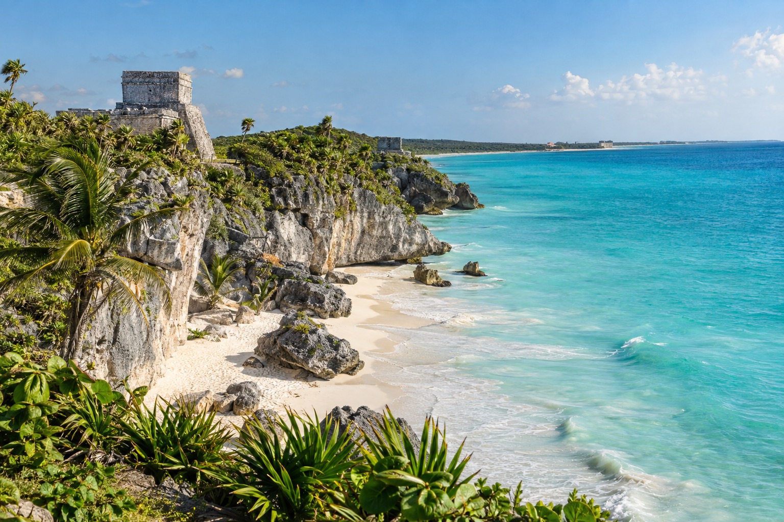Stone ruins on a coastal cliff above turquoise Caribbean water near Tulum