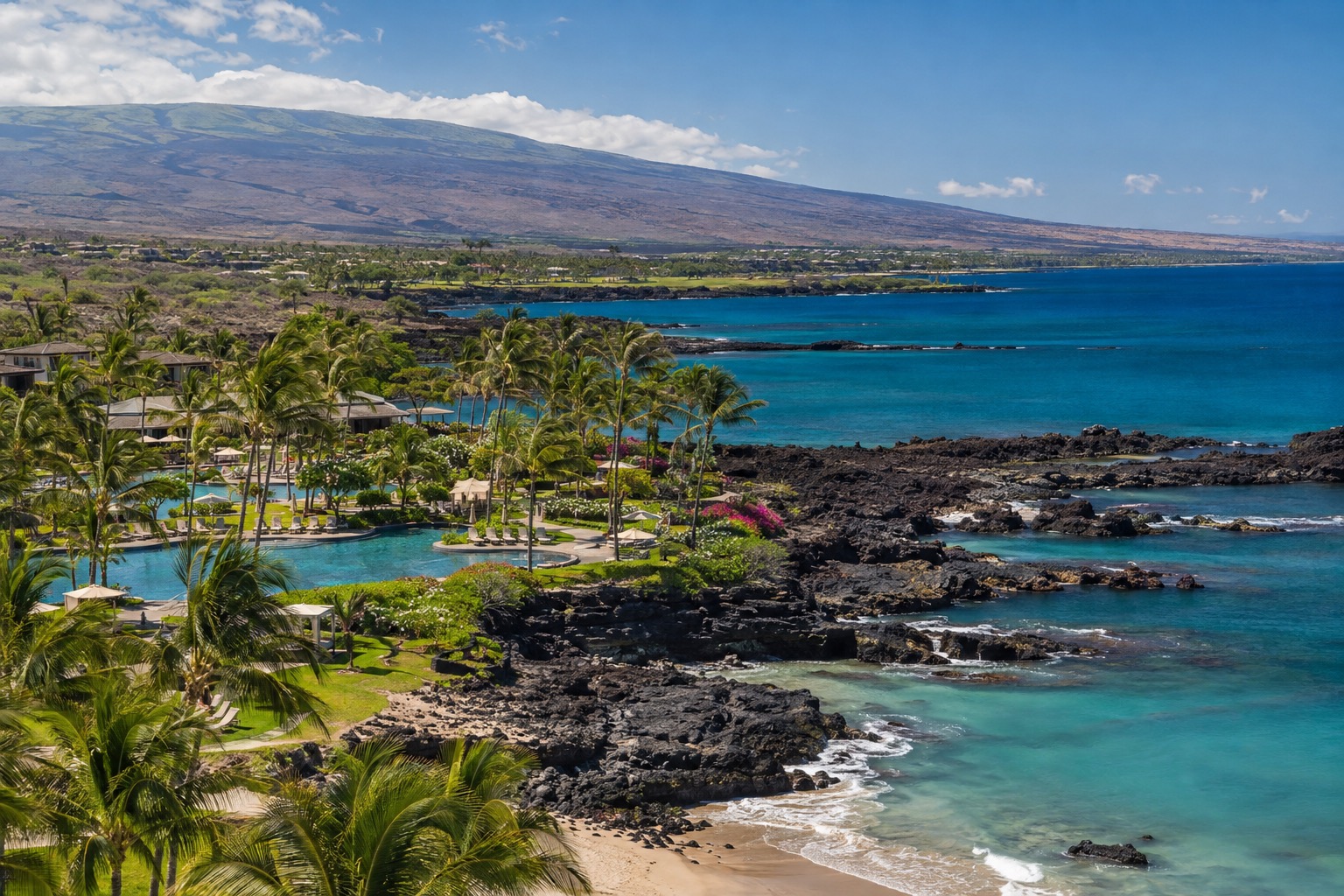 Resort pools and palm-lined paths along Waikoloa's Kohala coast shoreline