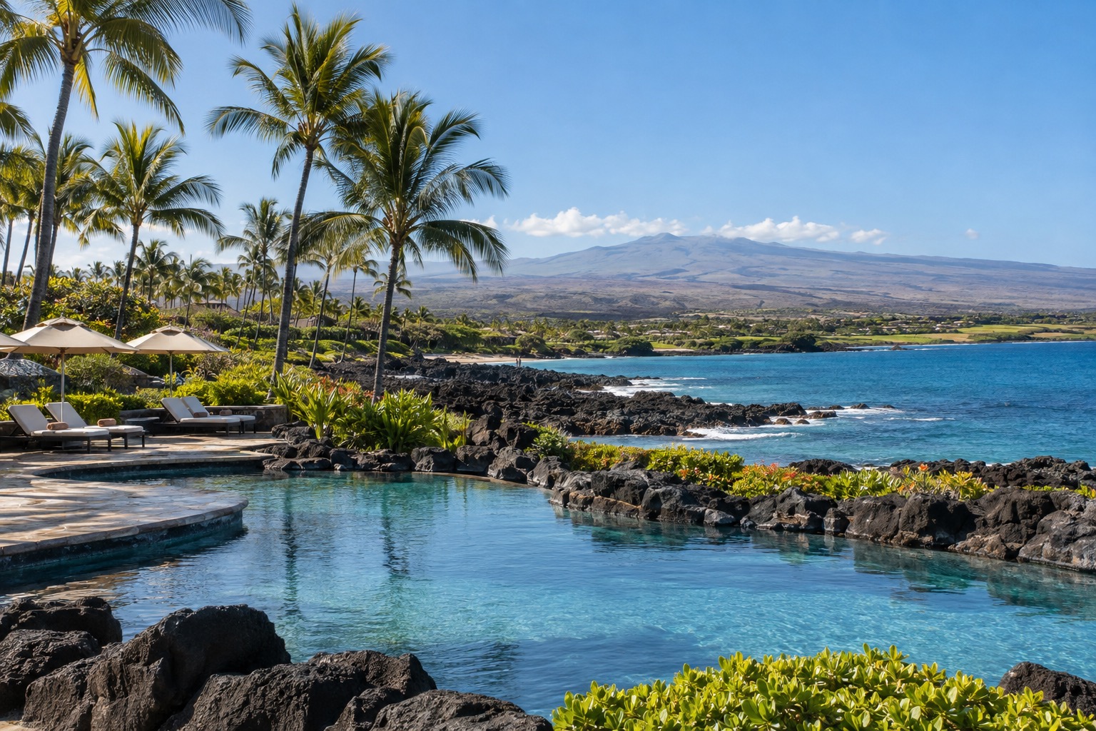Palm-lined pool deck and lava-rock landscaping at a Waikoloa resort on a clear January afternoon