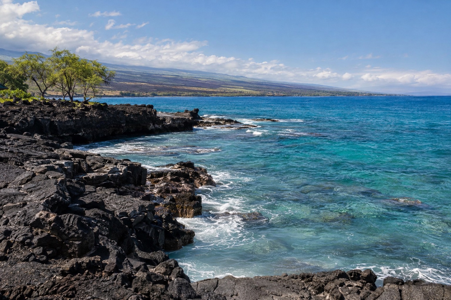 A dry lava-rock coastline with a stone platform and ocean in the background near Waikoloa