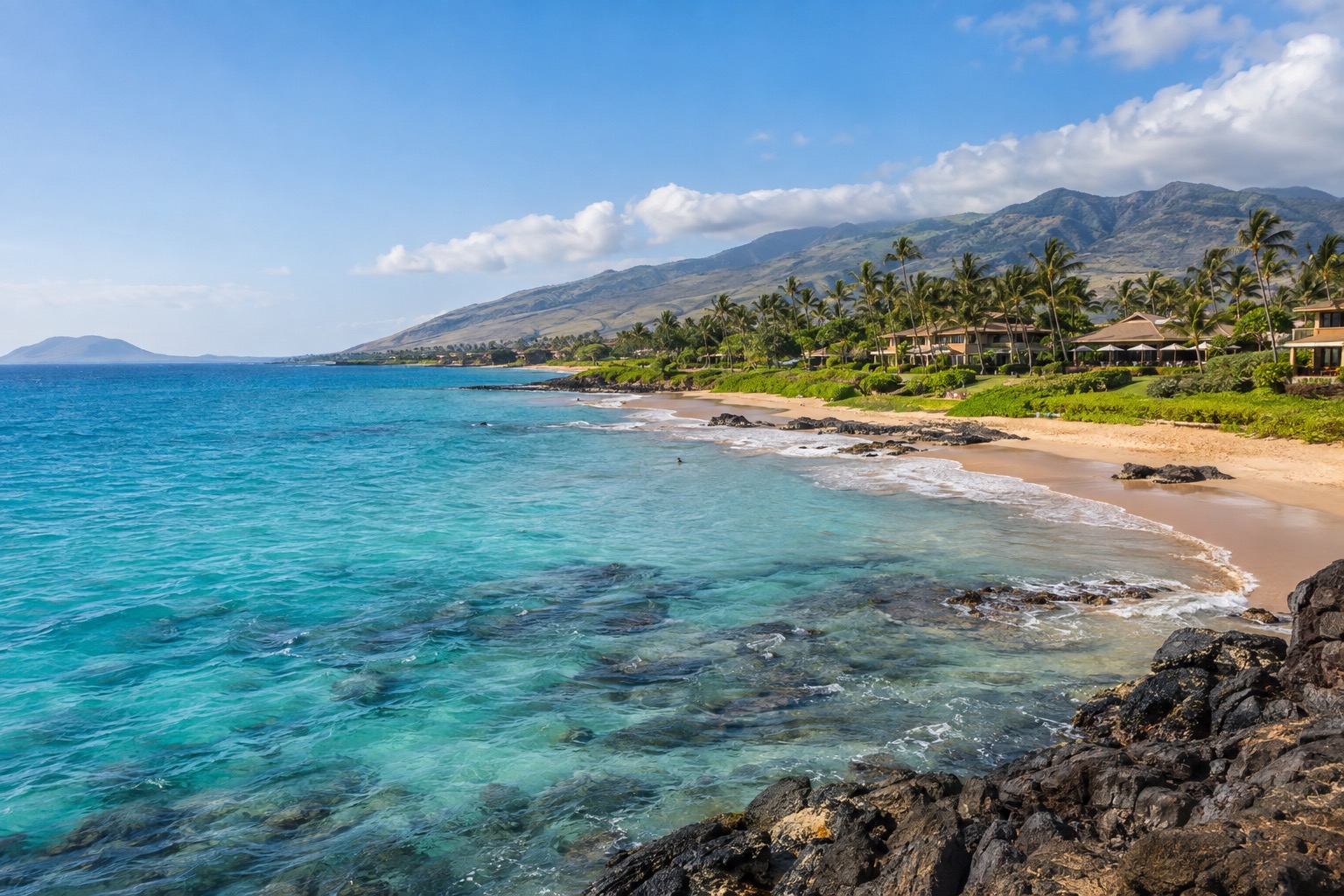 Turquoise water and a crescent white-sand beach along Wailea's coastline in South Maui