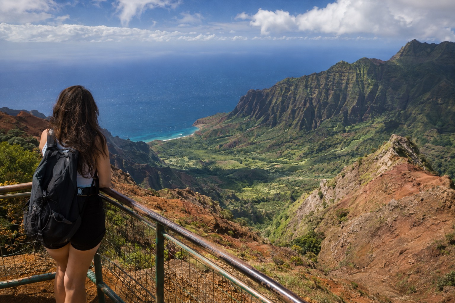 A lookout platform above layered red and green cliffs at Waimea Canyon on Kauai