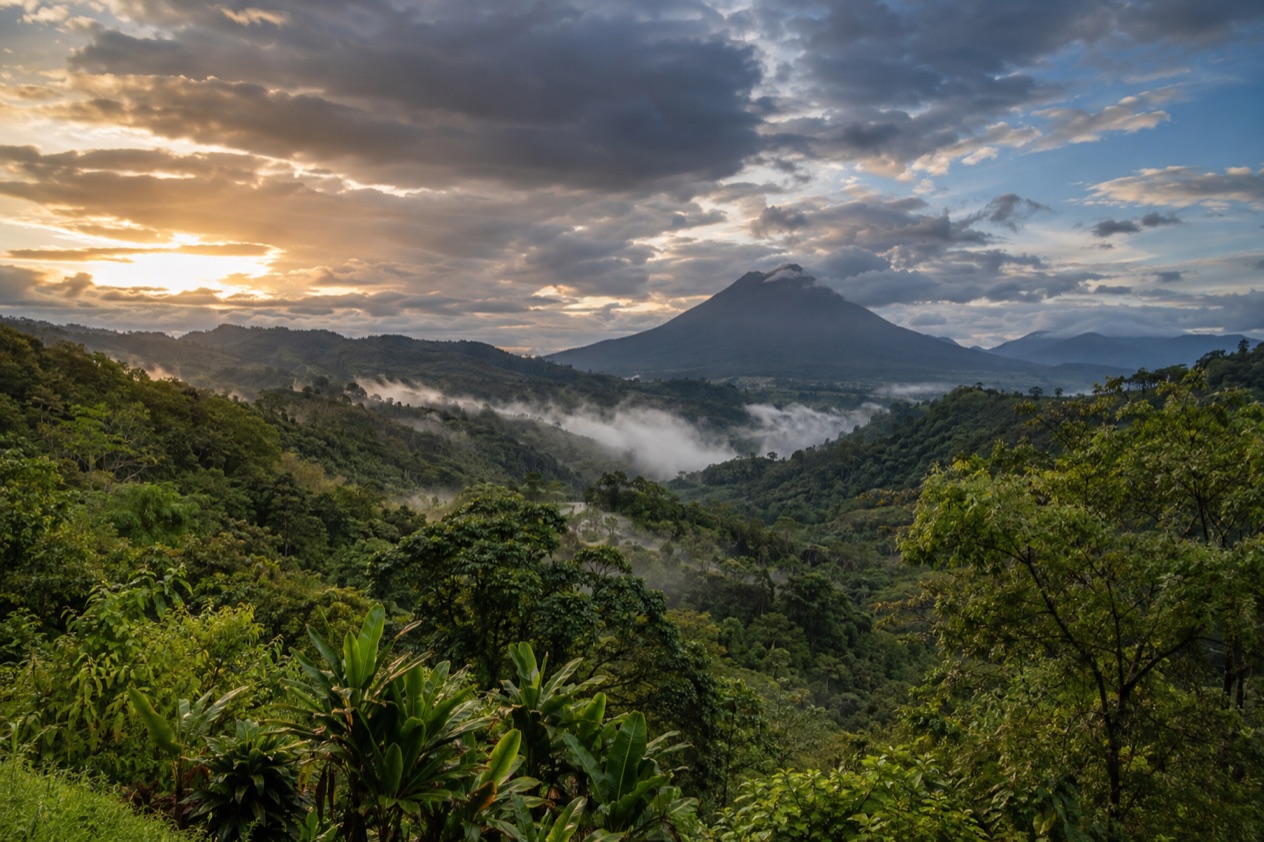 Green hills and a volcano in Costa Rica in the rainiest months