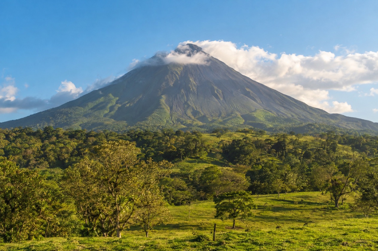 Arenal Volcano above the fields near La Fortuna in the dry season