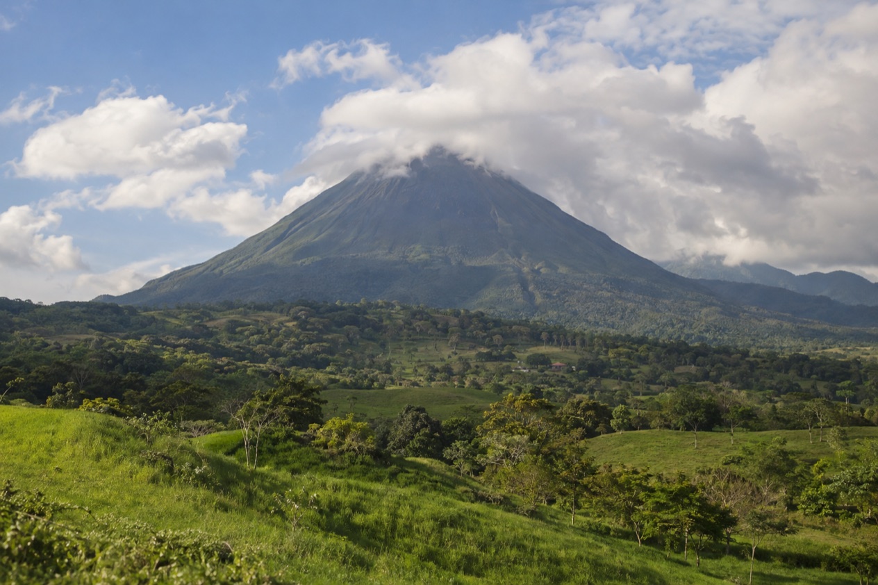 Arenal Volcano above the fields near La Fortuna