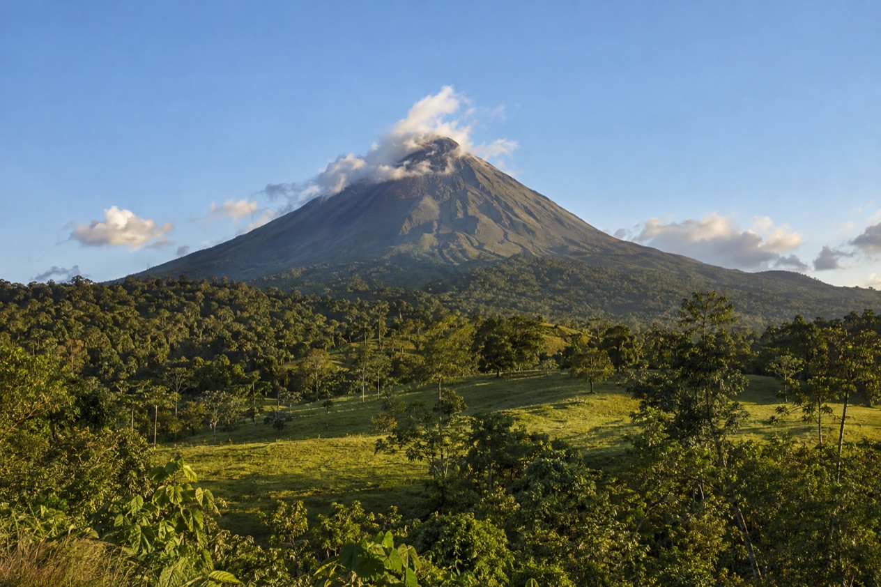 Arenal Volcano above the fields near La Fortuna in the dry season
