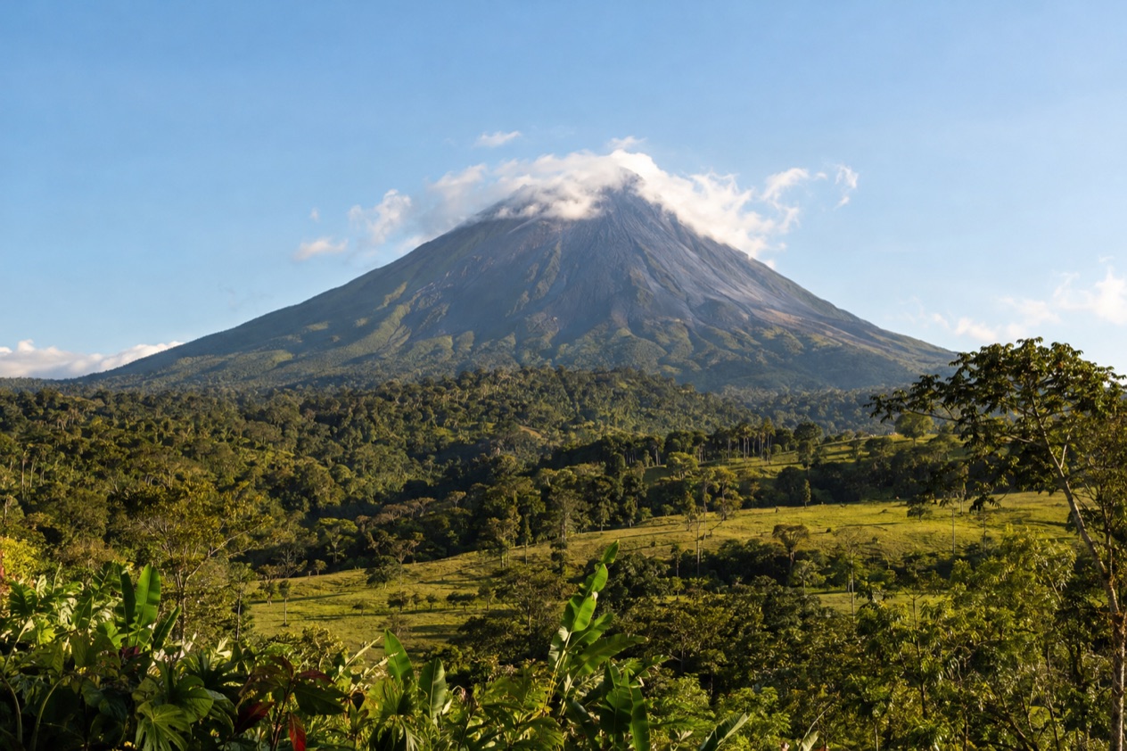 Arenal Volcano above the fields near La Fortuna in the dry season