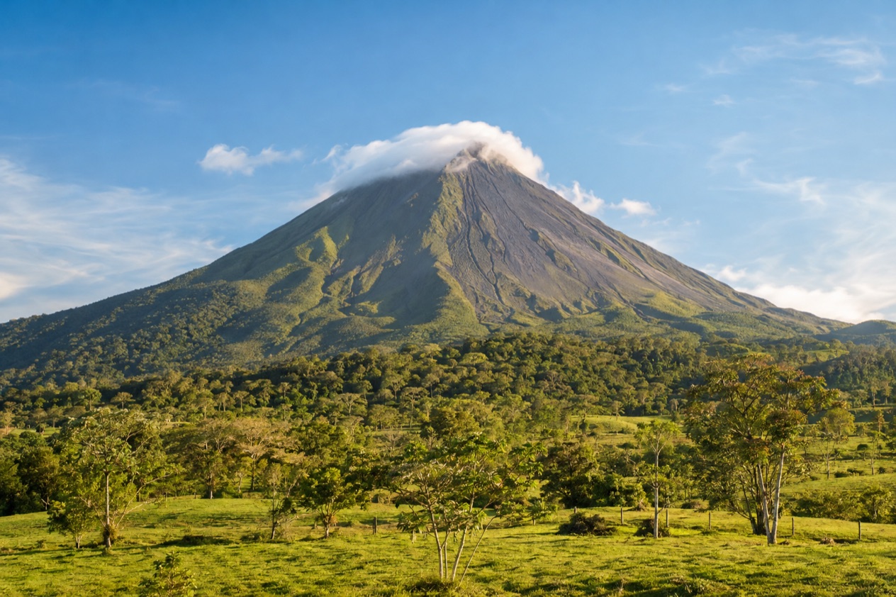 Arenal Volcano above the fields near La Fortuna in the dry season