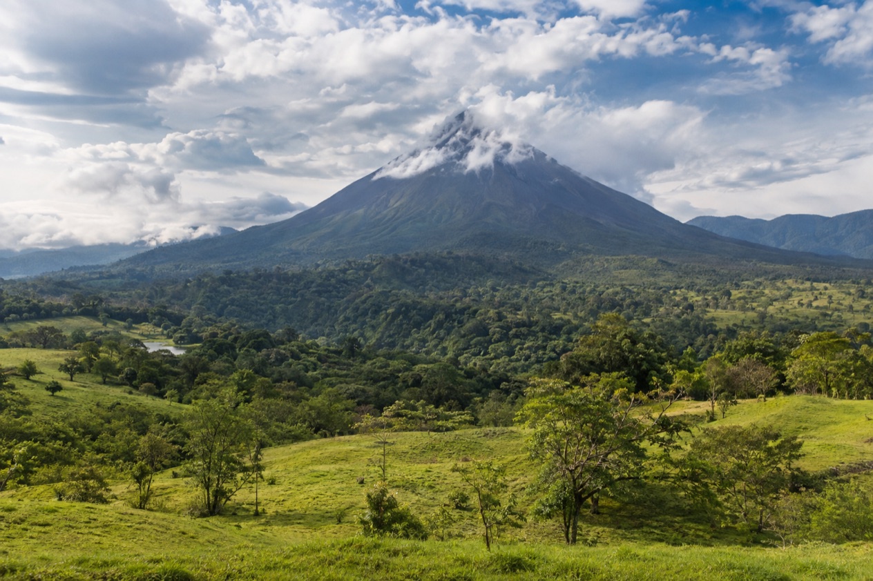 Arenal Volcano above the fields near La Fortuna in the green season