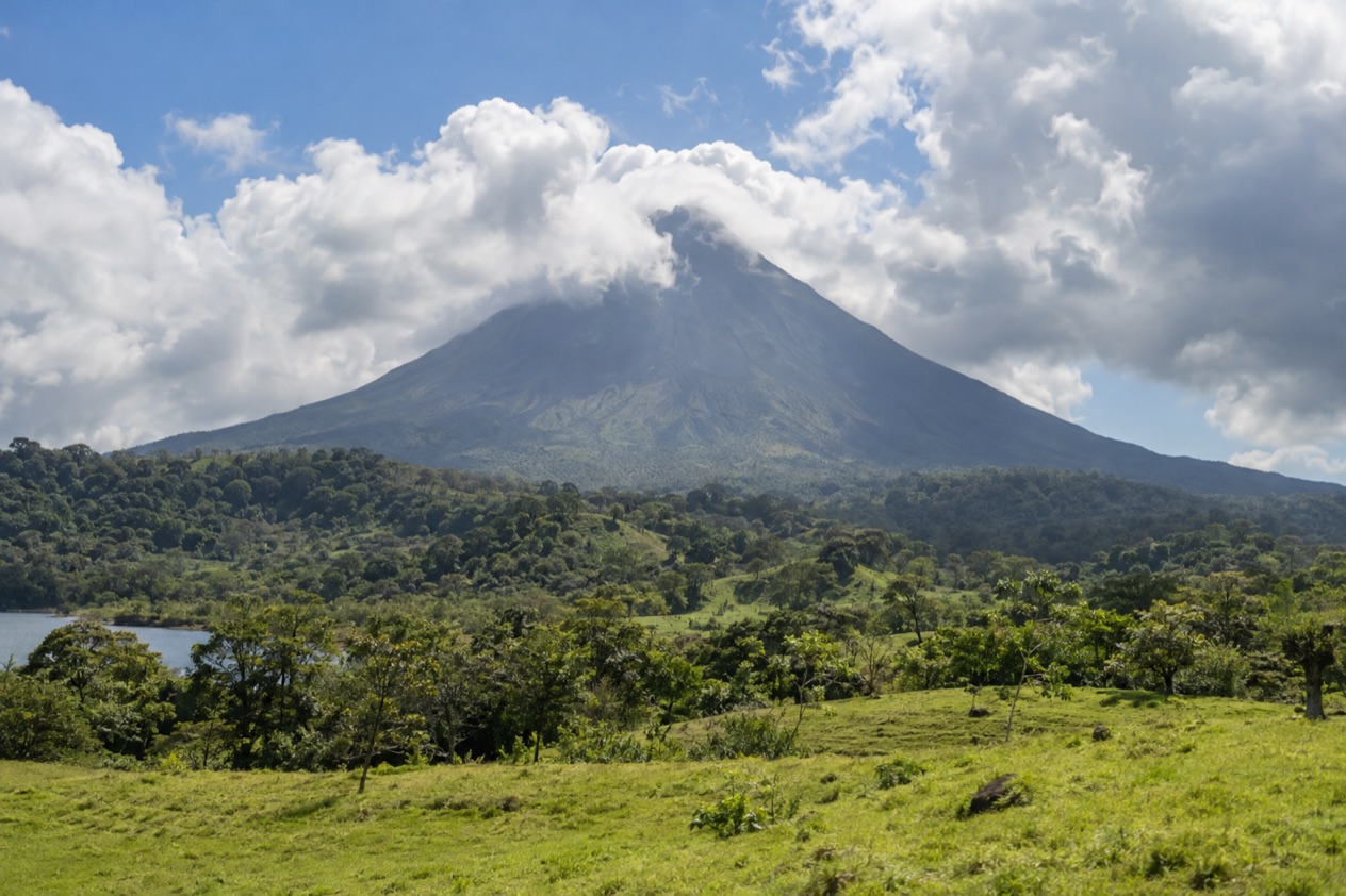 Arenal Volcano above the fields near La Fortuna in the green season