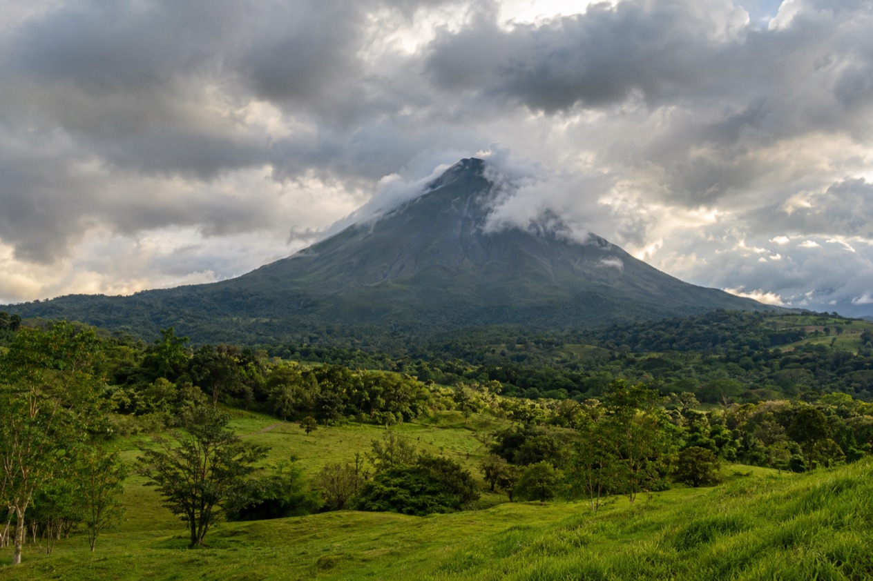 Arenal Volcano above the fields near La Fortuna in the rainiest months